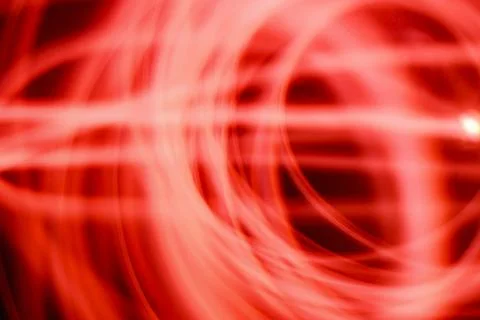 Abstract image of red neon light painting in a circular and spiral pattern .. Stock Illustration