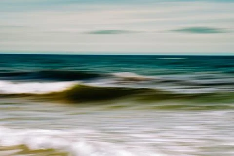 Abstract image of waves in motion with a smooth, serene seascape. Stock Photos