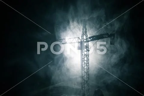 Abstract Industrial background with construction crane silhouette over amazin Stock Photos