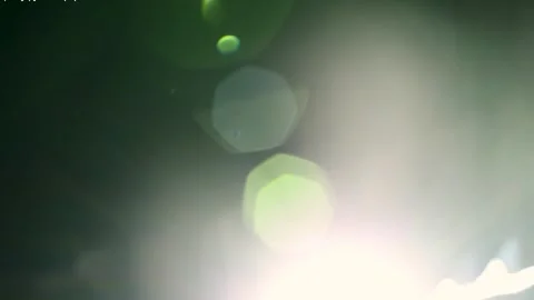 Abstract intense lens flare and anamorphic light leaks on black background Stock Footage 345960764