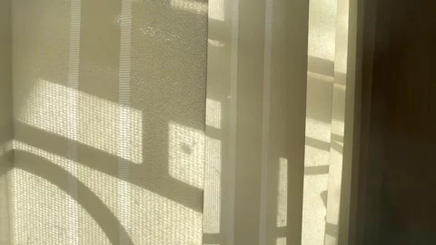 Abstract interior footage showing soft shadows cast through a sheer curtain. Stock Footage 326336282