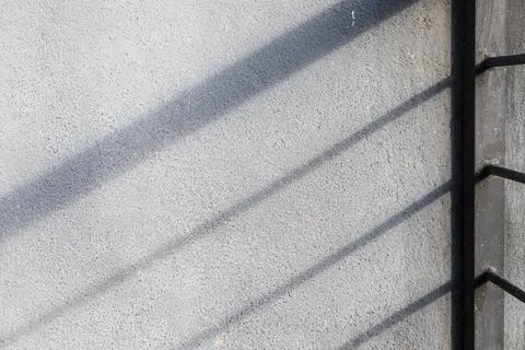 Abstract interior fragment with shadows pattern on gray concrete wall Stock Photos