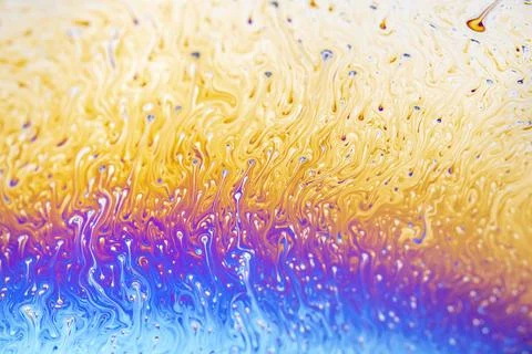 Abstract iridescent patterns of a soap bubble surface in vibrant colors 스톡 사진