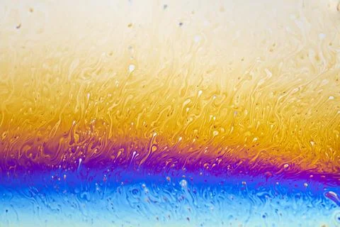 Abstract iridescent soap bubble surface with vibrant swirling colors and pa.. Stock Photos