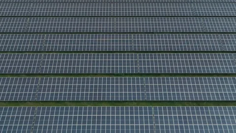Abstract Lateral Drone Close-Up of Solar Panels in Green Grass Field | Stock Footage 337152604