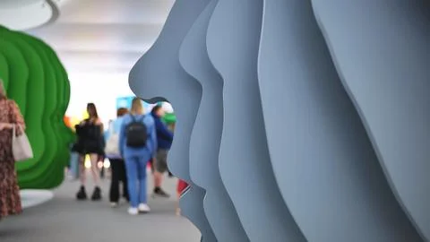 Abstract layered faces sculpture creating modern art installation in public Stock Photos