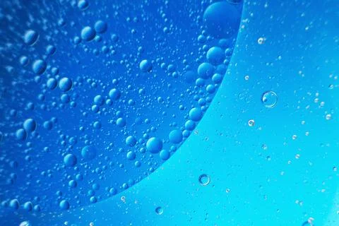 Abstract light blue background with oil circles . bubbles of water close up . Fotos Stock