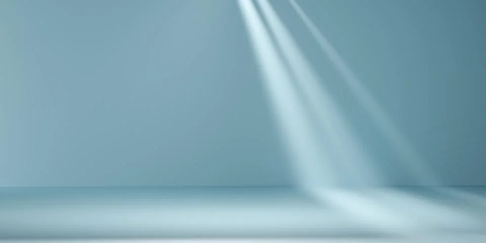 Abstract light blue studio background with bright sunbeams and soft shadows.. 스톡 사진