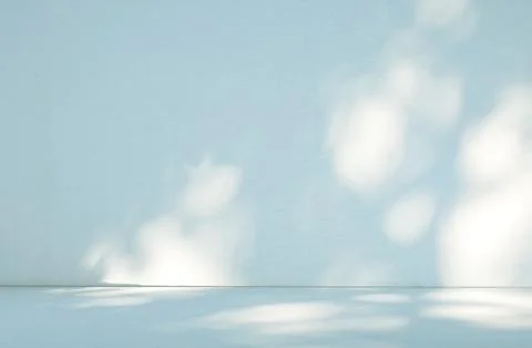 Abstract light blue wall background in empty room with light and shadow. Stock Photos