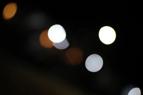 Abstract light bokeh on a dark background festive wallpaper Stock Photos