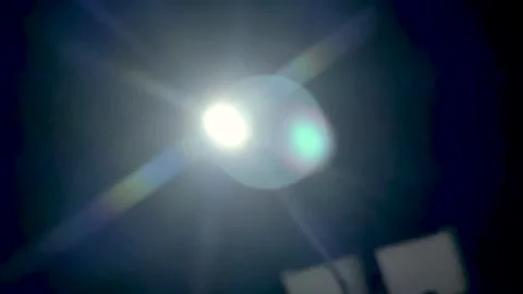 Abstract light burst with lens flare against dark sky and subtle geometric .. Video stock 339425306