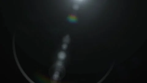 Abstract light flare on black background. Glowing lens flare effect for digital 스톡 동영상 339646503