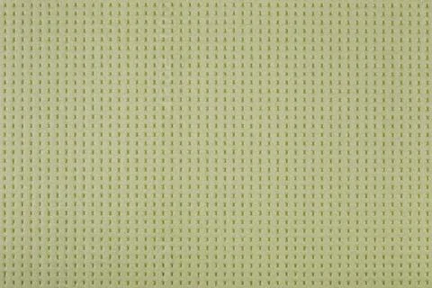 Abstract light green background, perforated surface of expanded polystyrene,  Foto stock