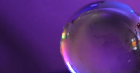 Abstract light illuminates a glass globe representing global Vídeos de archivo 347310438