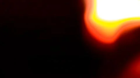 Abstract light leak with glowing yellow and red hues on black background Stock Illustration