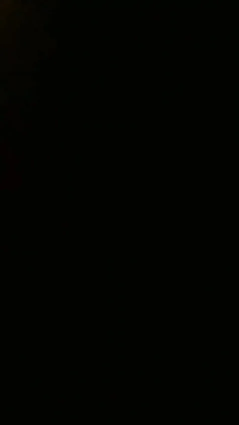 Abstract light leak transition effect with glowing golden particles on a dark Video stock 347485167