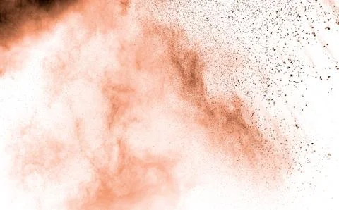 Abstract light orange powder explosion on white background. Stock Photos