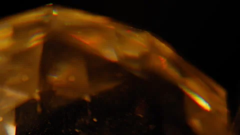 Abstract light from an orange prism against a black background Stock Footage 345514245