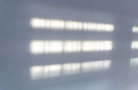 Abstract light patterns create a subtle interplay on a white surface, showcasing Stock Photos