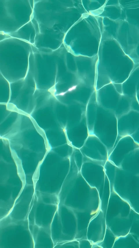 Abstract light patterns on shimmering turquoise swimming pool water surface.. Stock Footage 334318370