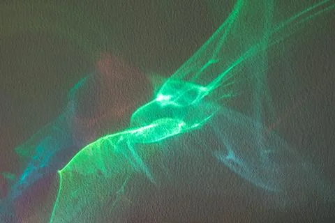Abstract light projection on textured wall with green neon wave and motion blur Stock Photos