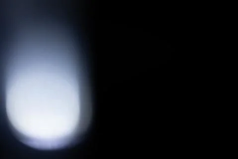 Abstract light ray illuminating dark black background Stock Photos