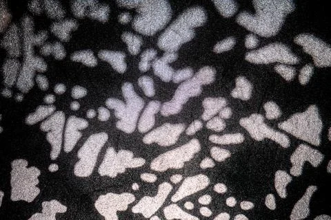 Abstract light spots pattern on dark surface Foto stock