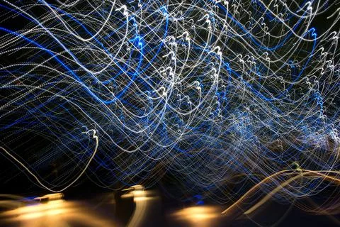 Abstract light streaks background pattern against black Stock Photos