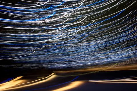 Abstract light streaks background pattern against black Stock Photos