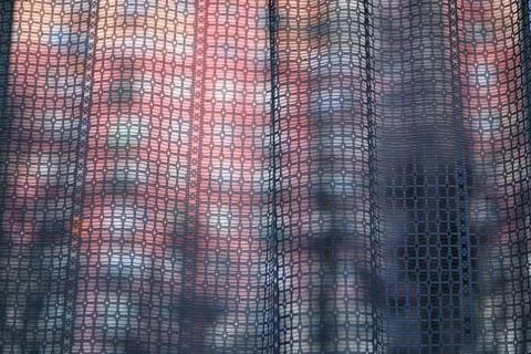 Abstract light streaming through a curtain in a dark room with a building b.. Stock Photos