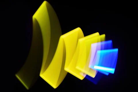 Abstract Light Waves. Vibrant abstract light waves in yellow and blue against a Stock Photos