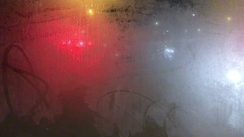 Abstract lights and images - traffic through frosted glass bus shelter window Stock Footage 99596410