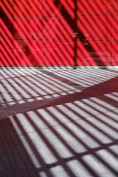 Abstract lines of a shadow of architectural elements of a building on a sidew Stock Photos
