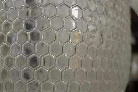 Abstract liquid viewed through hexagonal glass Stock-Fotos