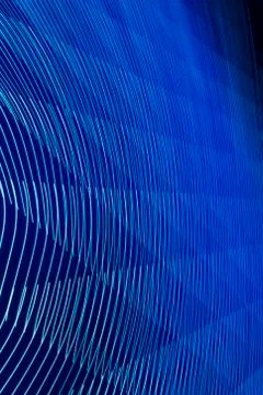 Abstract long exposure blurred light lines black and blue background. Geometric Stock-Illustration