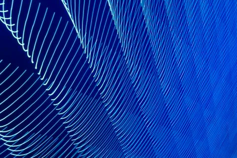 Abstract long exposure blurred light lines black and blue background. Geometric Stock-Illustration