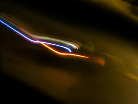 Abstract long exposure light trails with blue white and orange red streak c.. Stock Photos