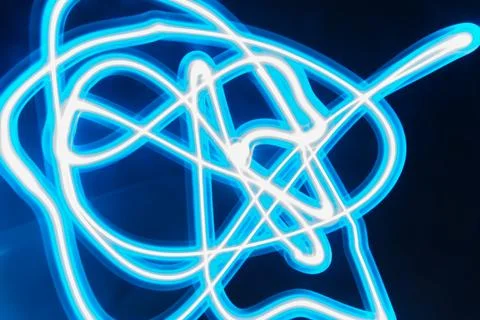 Abstract long exposure of tangled blue glowing light trails Stock Photos