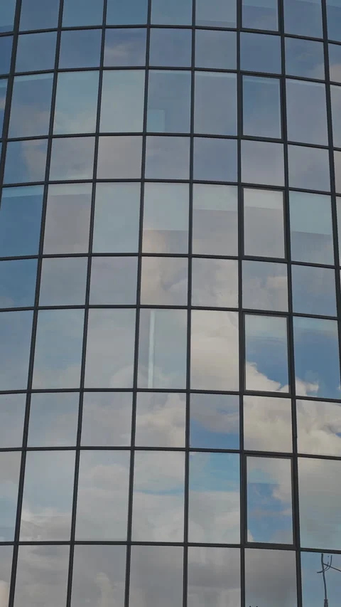 Abstract low angle view of a contemporary office building's glass facade Video stock 342610913