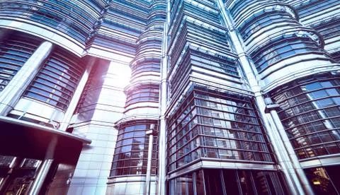 Abstract low angle view of contemporary glass structure skyscraper against cl Stock Photos