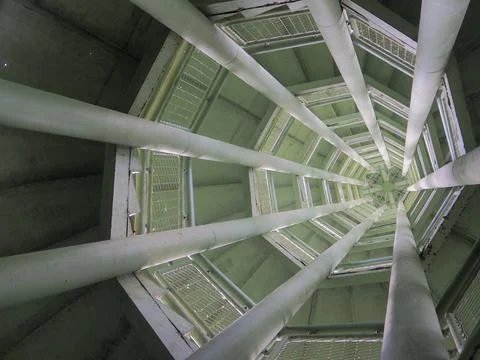 Abstract, low-angle view looking straight up into the core of a modern stru.. Stock Photos