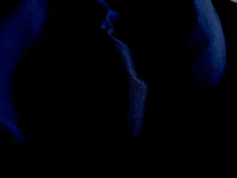 Abstract low light portrait with blue highlights in darkness. Stock Photos