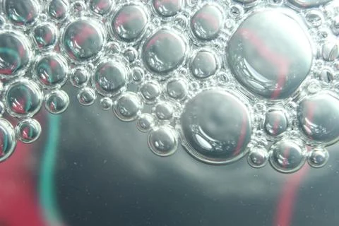 Abstract macro background of oil circles floating over water surface . Stock Photos