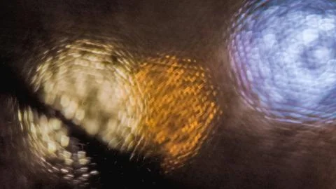 Abstract macro bokeh light through fabric texture, defocused circular light.. Stock Photos