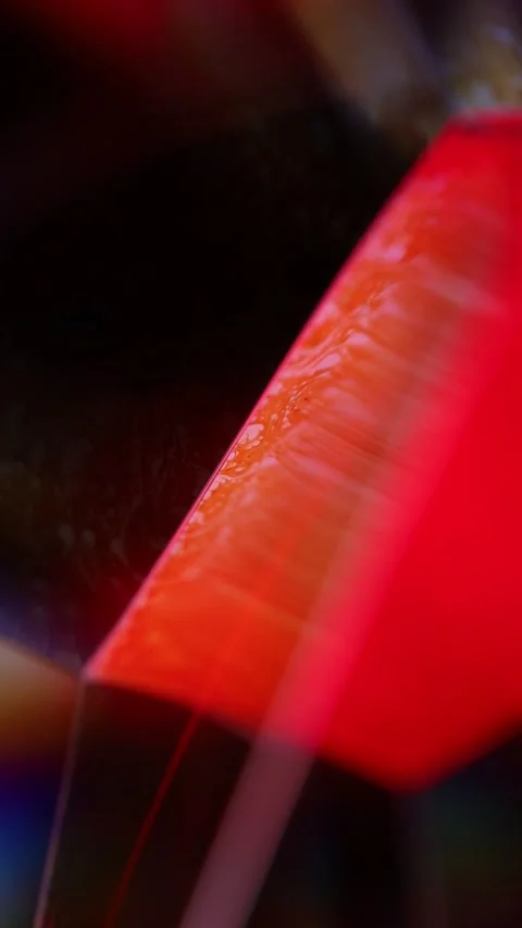Abstract Macro of Glowing Red Liquid Ripple on Dark Angular Surface Stock Footage 334110081
