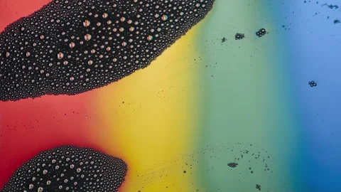Abstract macro movie of multiple reflections of the rainbow in foam Stock Footage 142730060