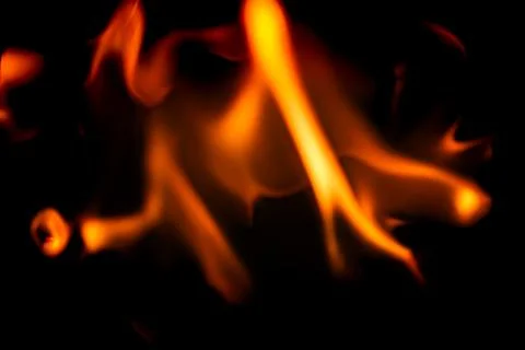 Abstract macro shot of blurry fire flames isolated on black background Stock Photos
