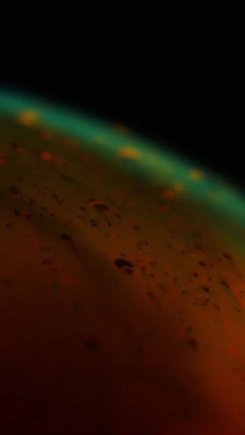 Abstract macro shot of dark red liquid surface with floating bubbles and glowing Stock-Footage 347692421