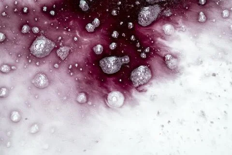 Abstract macro shot of dark red liquid, ink, or chemical reacting with a wh.. Fotos de archivo