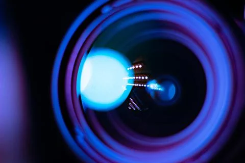 Abstract Macro View of a Camera Lens with Neon Reflections Stock Photos